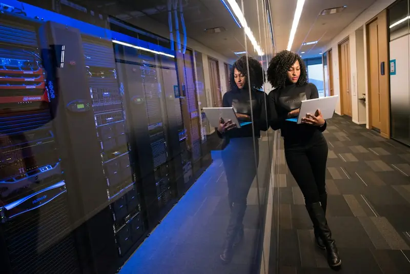 Security engineer with a tablet in a server room